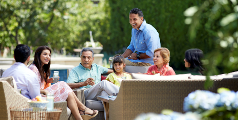 Multigenerational family seated outside.