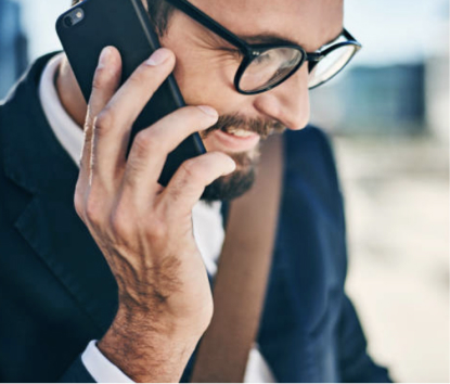 man holding phone up to his ear and smiling