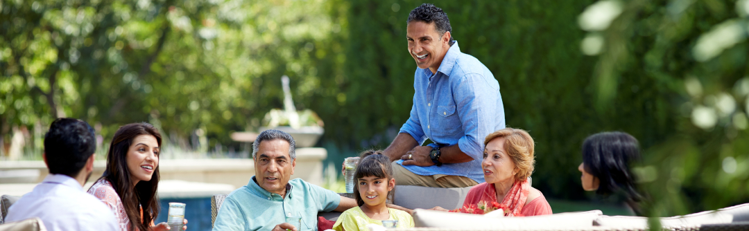 Multigenerational family seated outside talking