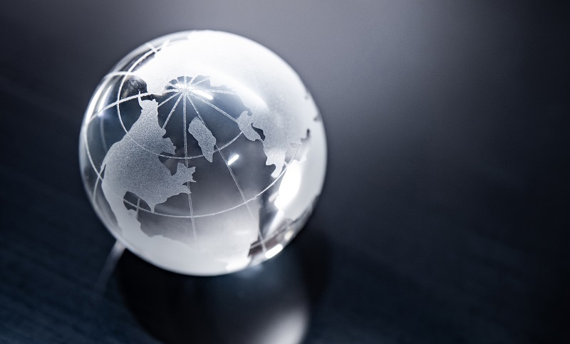 A glass globe on a black surface