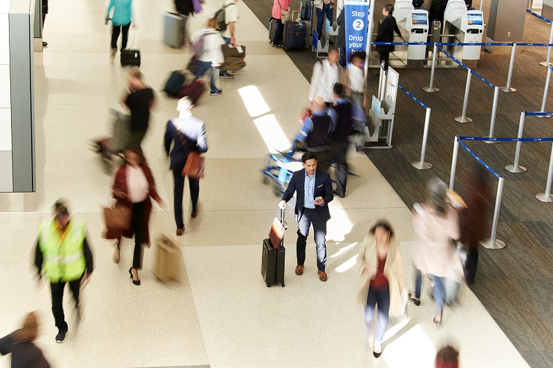 people moving back and forth in airport terminal